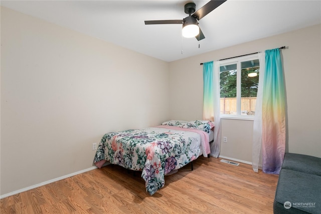 bedroom with ceiling fan and light wood-type flooring