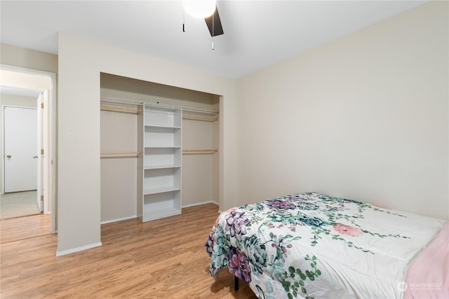 bedroom featuring ceiling fan, a closet, and light hardwood / wood-style flooring