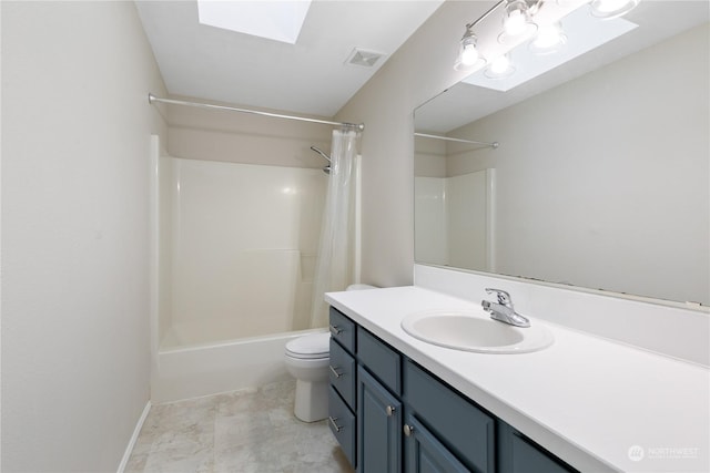 full bathroom with a skylight, vanity, shower / tub combo, and toilet