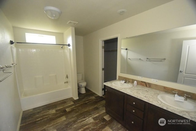 full bathroom with vanity, hardwood / wood-style floors, shower / bathing tub combination, and toilet