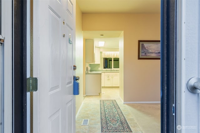 hallway with light tile patterned floors