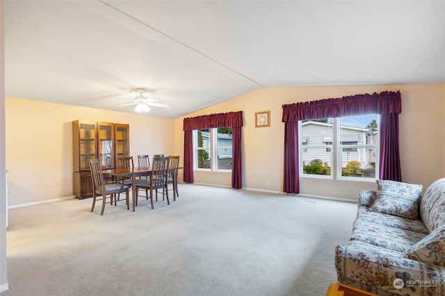 living room featuring light colored carpet, ceiling fan, and lofted ceiling