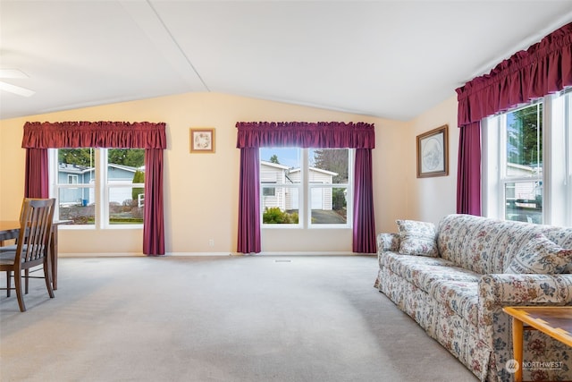 living room with light colored carpet, plenty of natural light, and lofted ceiling