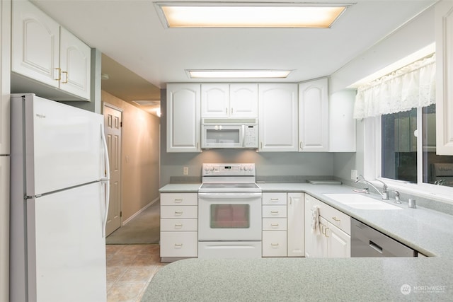 kitchen featuring white cabinetry, white appliances, and sink