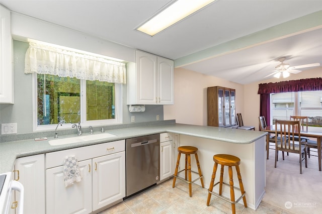 kitchen featuring kitchen peninsula, ceiling fan, sink, dishwasher, and white cabinetry