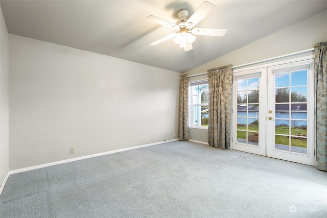 empty room with carpet, ceiling fan, lofted ceiling, and french doors