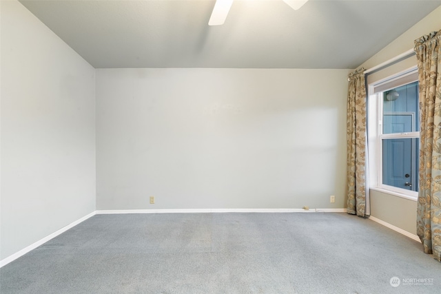 carpeted spare room with ceiling fan