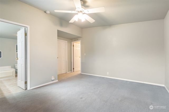 empty room featuring light carpet and ceiling fan