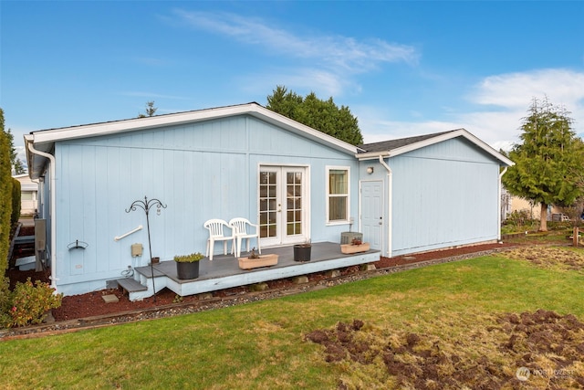 back of house with a yard and french doors