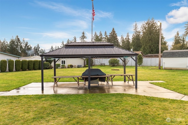 view of community with a gazebo, a patio, and a lawn