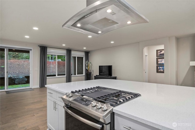 kitchen featuring white cabinetry, stainless steel range with gas cooktop, wood-type flooring, and island range hood