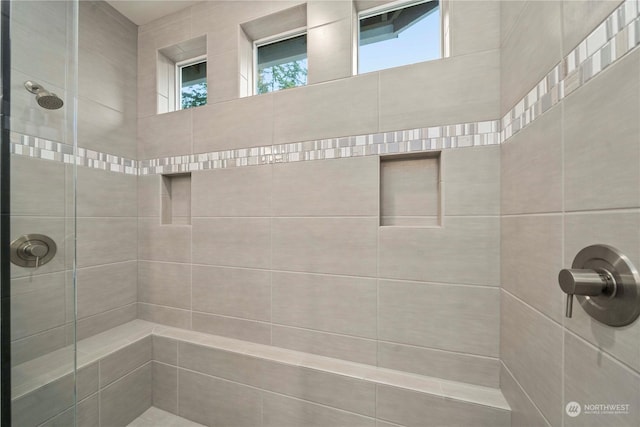 bathroom featuring a tile shower