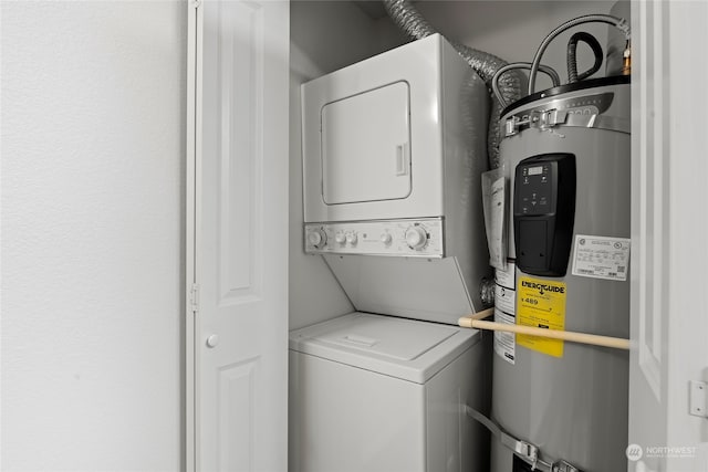 washroom featuring water heater and stacked washer and clothes dryer