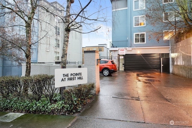 300 10th Ave Unit B-105, Seattle, WA 98122 - community sign with concrete driveway and an attached garage