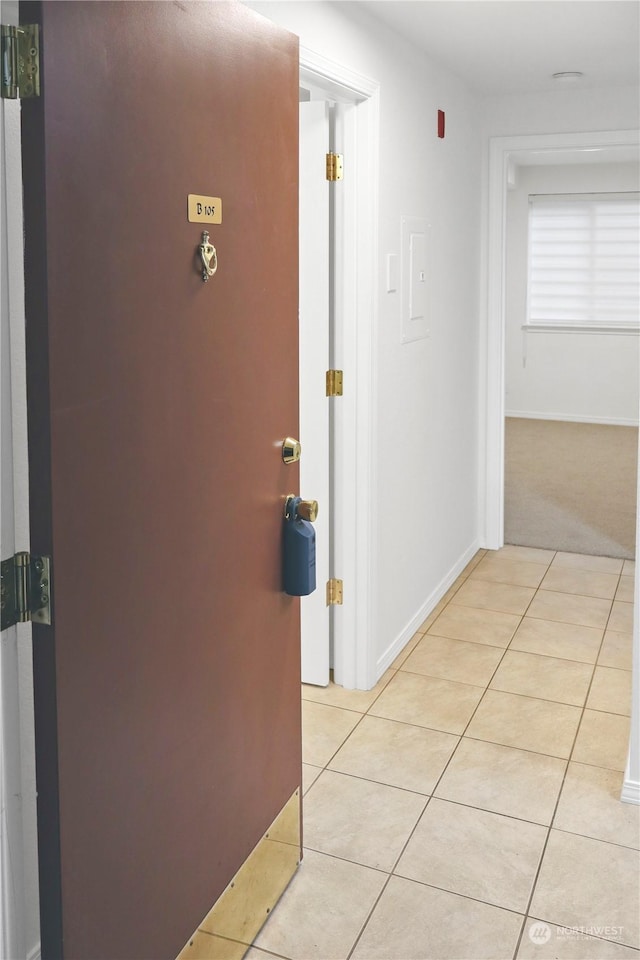 hallway featuring light tile patterned floors