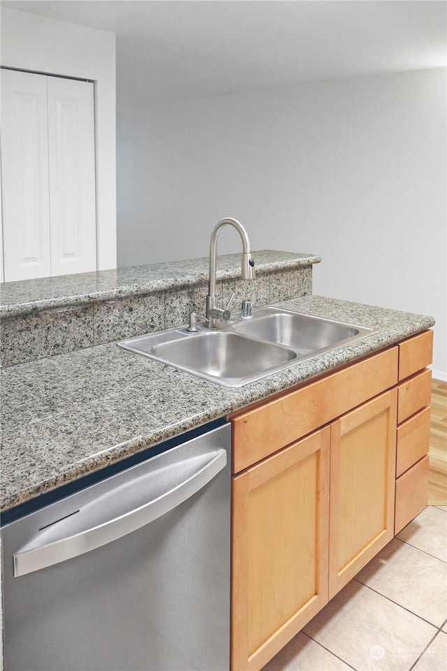 kitchen featuring dishwasher, light tile patterned floors, sink, and light brown cabinetry