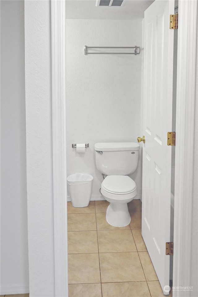 bathroom with tile patterned floors and toilet