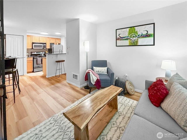 300 10th Ave Unit B-105, Seattle, WA 98122 - living area featuring baseboards and light wood finished floors