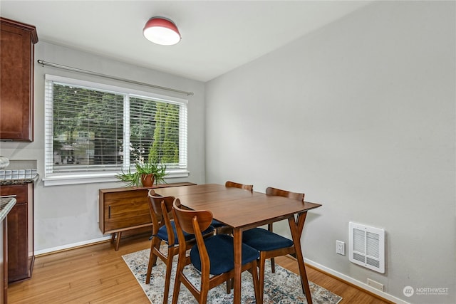 dining space with light hardwood / wood-style floors