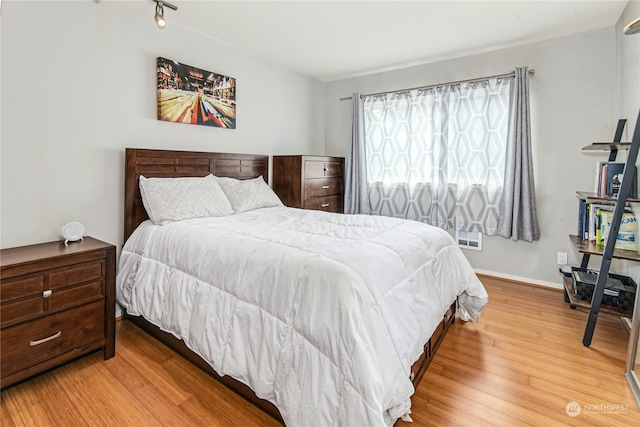 bedroom with hardwood / wood-style flooring