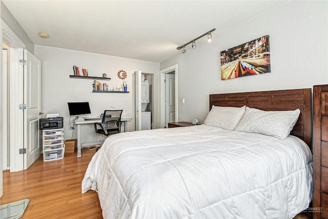 bedroom featuring wood-type flooring and rail lighting