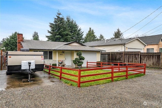 single story home with a garage and a front yard