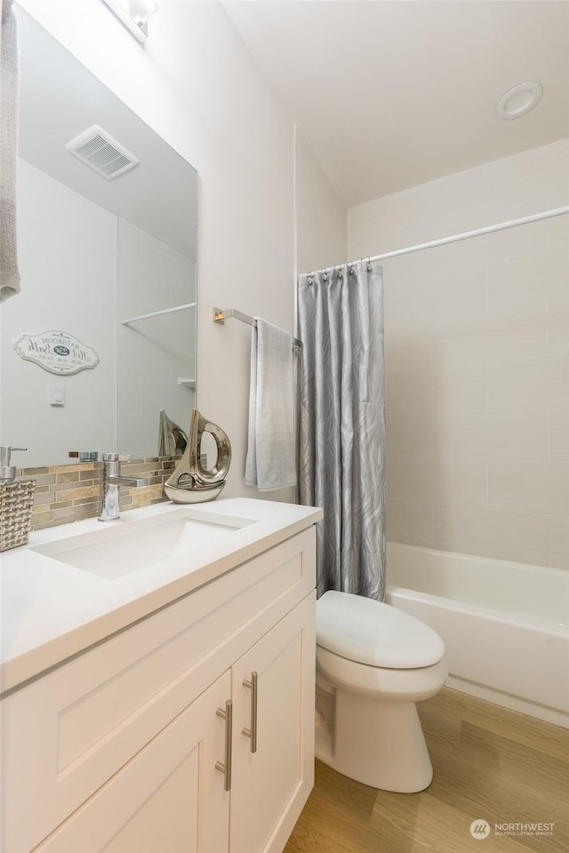 full bathroom with vanity, wood-type flooring, shower / bath combination with curtain, decorative backsplash, and toilet