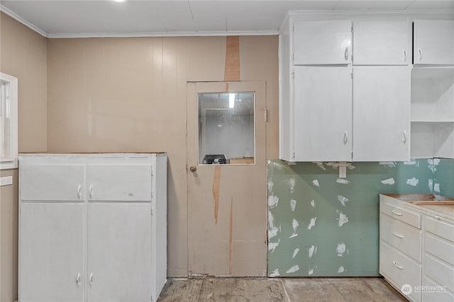 kitchen featuring white cabinets and ornamental molding