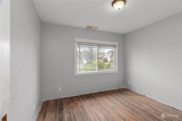 spare room featuring dark wood-type flooring