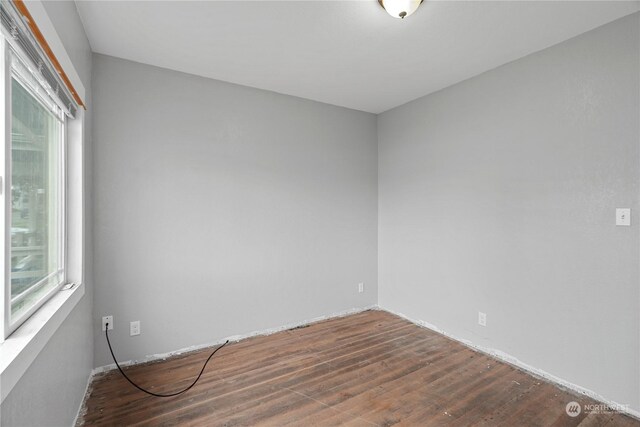 unfurnished room with dark hardwood / wood-style floors