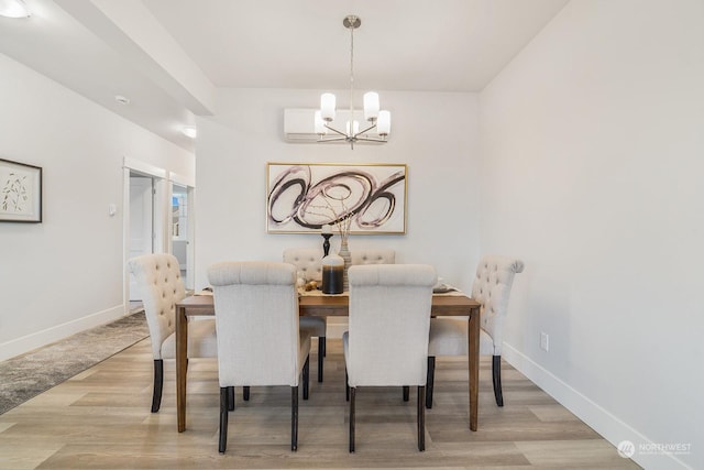 dining room with a notable chandelier and light hardwood / wood-style flooring