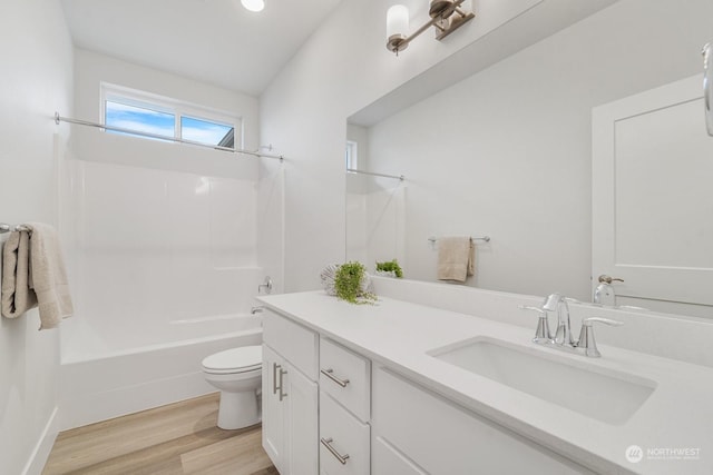 full bathroom featuring vanity, wood-type flooring, tub / shower combination, and toilet