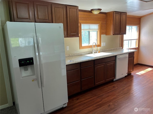 kitchen featuring dishwashing machine, a healthy amount of sunlight, white fridge with ice dispenser, and sink