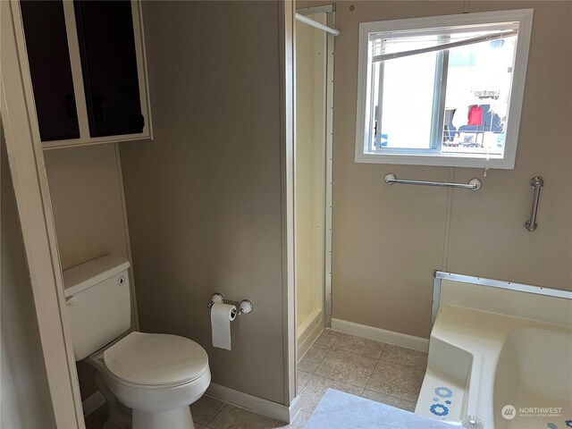 bathroom with tile patterned flooring, toilet, and walk in shower