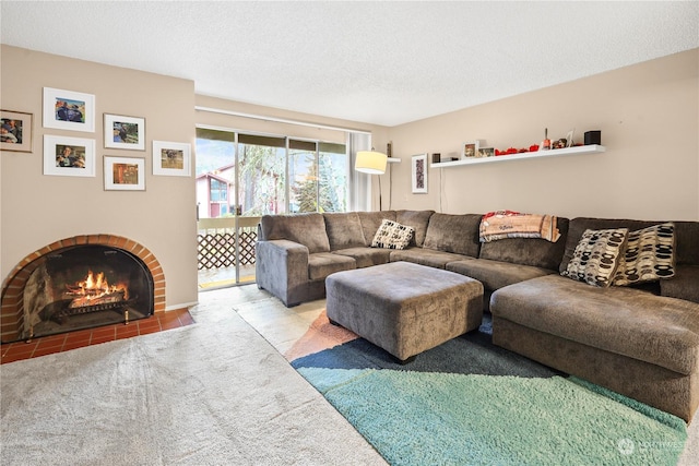 carpeted living room featuring a textured ceiling and a brick fireplace