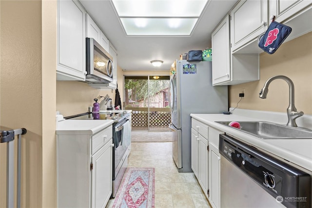 kitchen with a sink, light countertops, white cabinetry, and stainless steel appliances