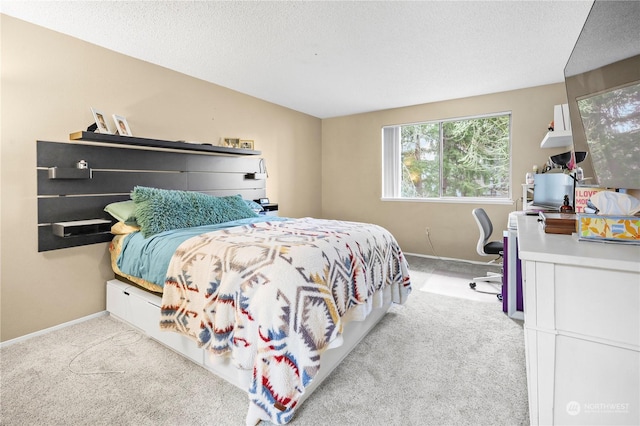 bedroom featuring carpet, baseboards, and a textured ceiling