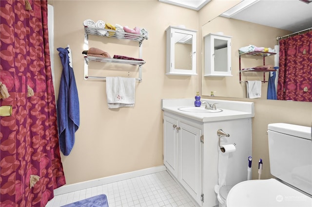 bathroom featuring tile patterned floors, toilet, vanity, and baseboards