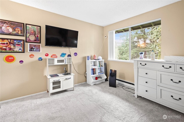 rec room featuring a baseboard heating unit, light colored carpet, and baseboards