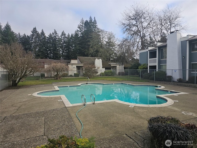 pool featuring a patio area and fence