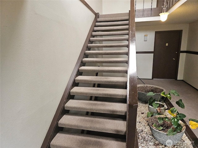 staircase with a textured wall