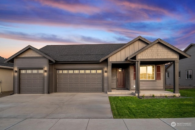 craftsman-style house featuring a garage and a yard