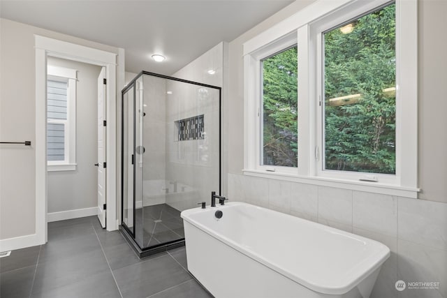 bathroom featuring tile patterned flooring and plus walk in shower