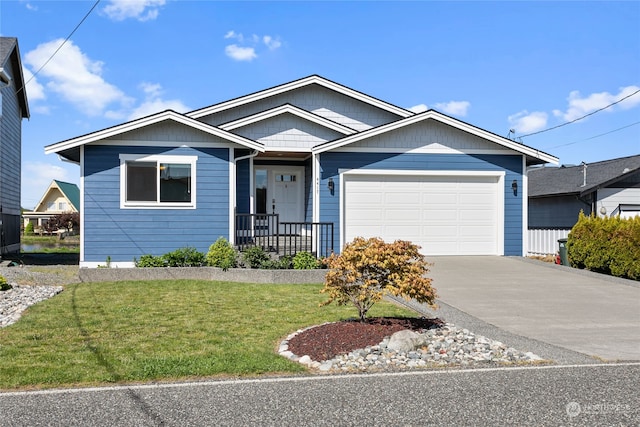 view of front of property with a garage and a front lawn