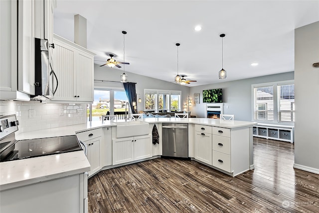 kitchen featuring sink, dishwasher, white cabinets, and range