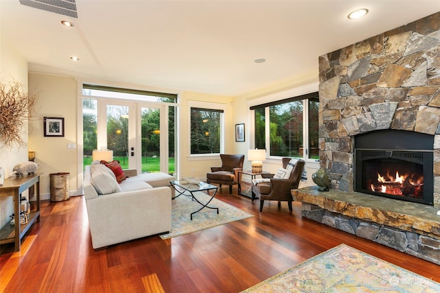 living room with dark hardwood / wood-style flooring, a fireplace, and french doors