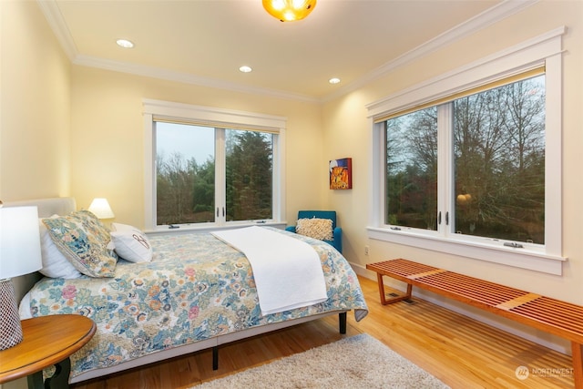 bedroom with hardwood / wood-style floors and ornamental molding