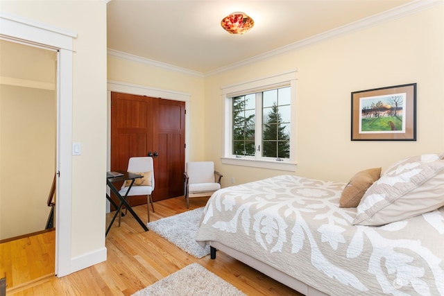 bedroom featuring light wood-type flooring and ornamental molding