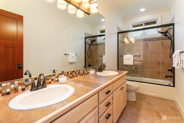 full bathroom featuring combined bath / shower with glass door, vanity, backsplash, and toilet