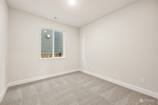 unfurnished room featuring carpet